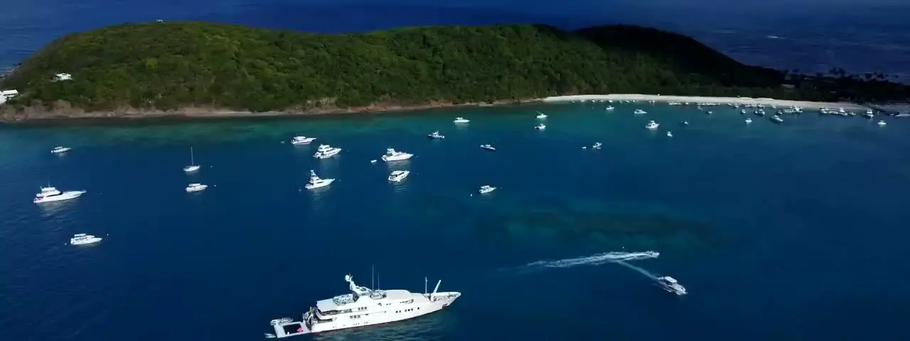 Private island with a superyacht and surrounding water