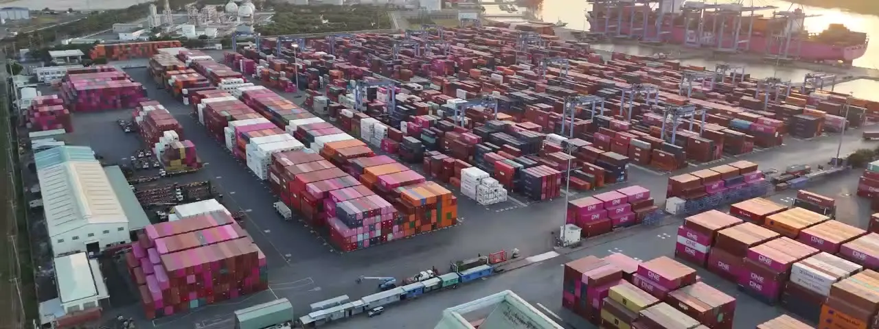 Container port with cranes, stacks, ship and water access