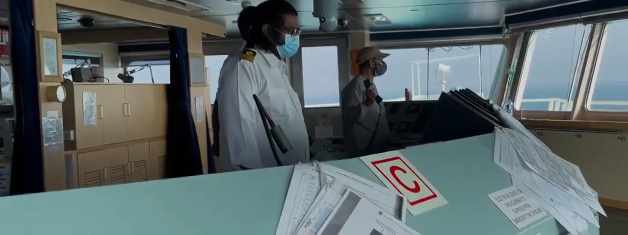 Crew briefing on a ship bridge