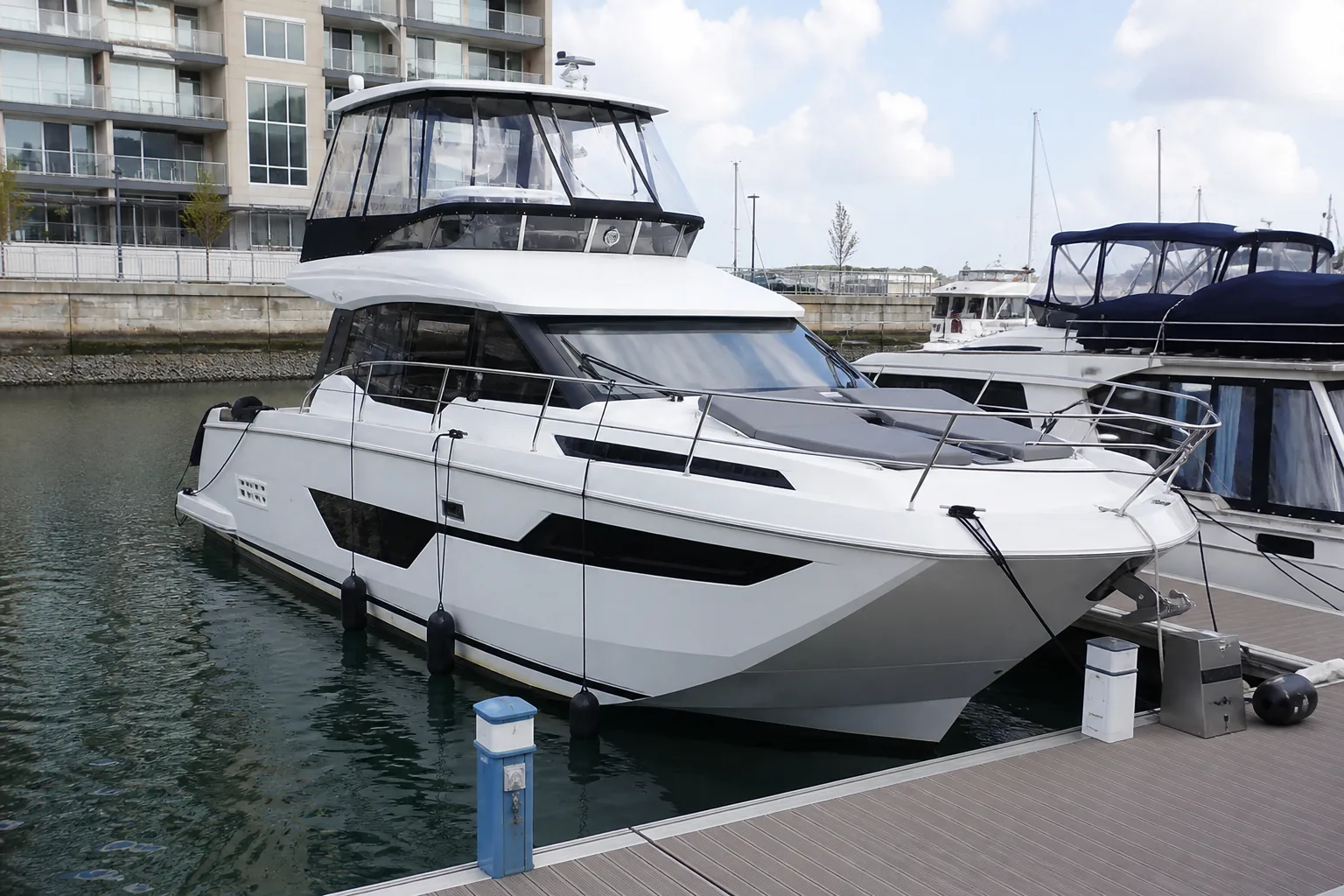 Motor yacht berthed alongside a marina dock