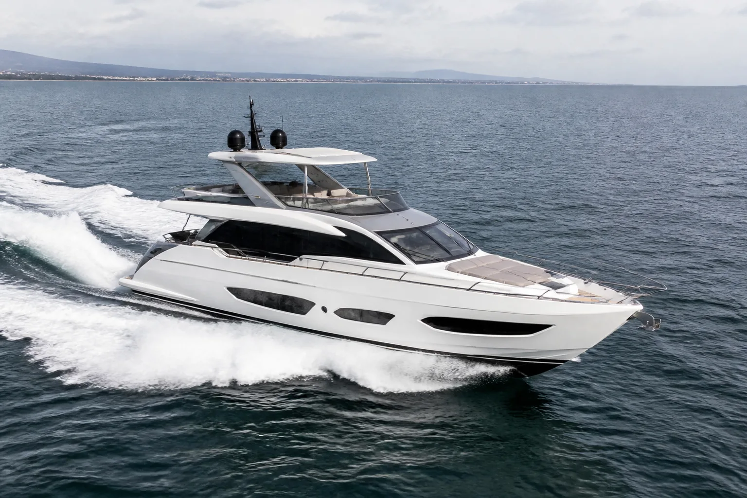Motor yacht underway with a visible wake